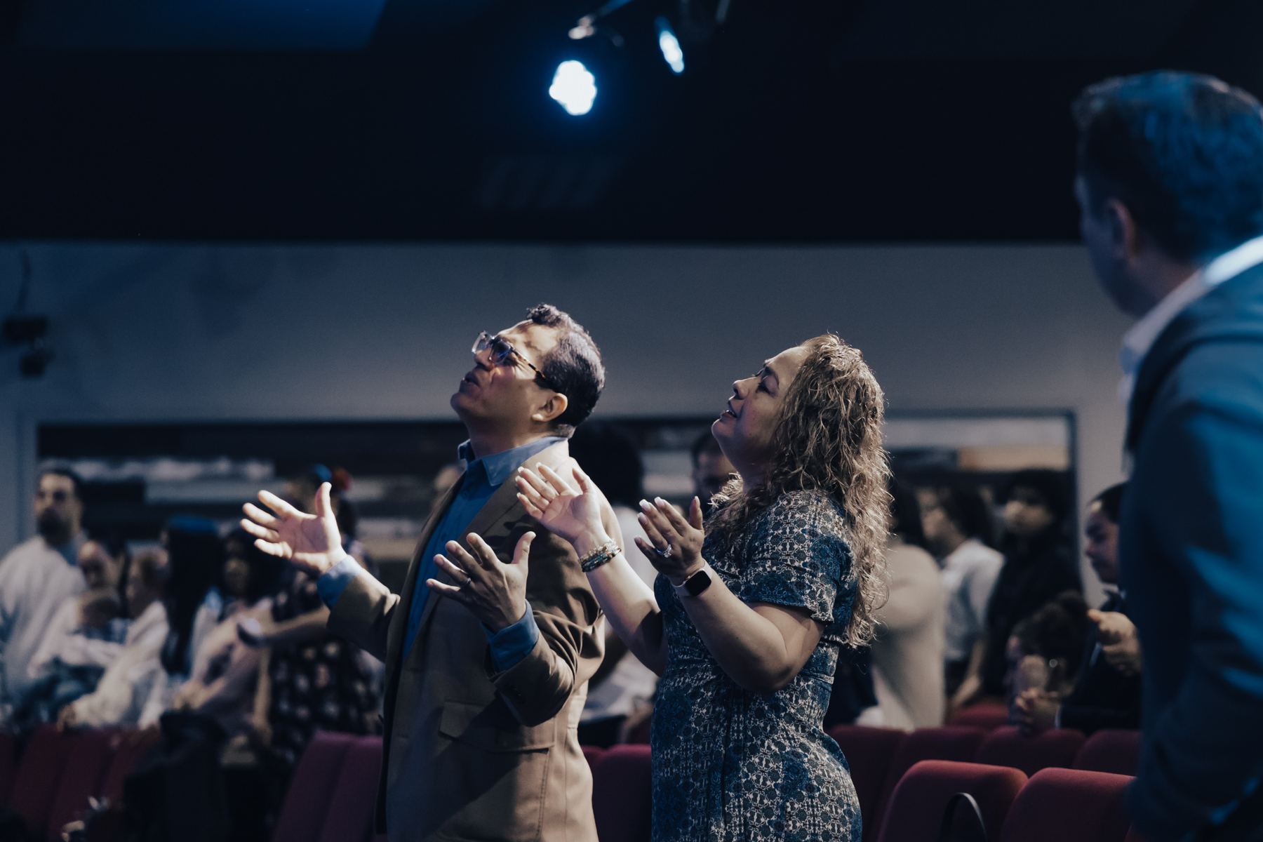 Pastors Estuardo and Claudia Cambranes worshiping during a service